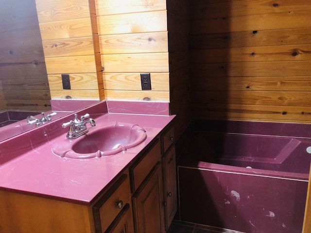 bathroom featuring vanity and wood walls