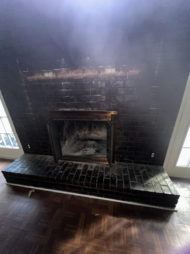 details with a fireplace and parquet flooring