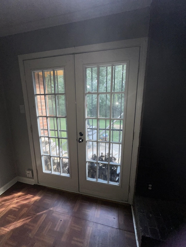 doorway to outside featuring dark parquet flooring and french doors