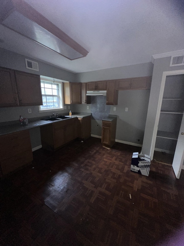 kitchen with sink and dark parquet flooring