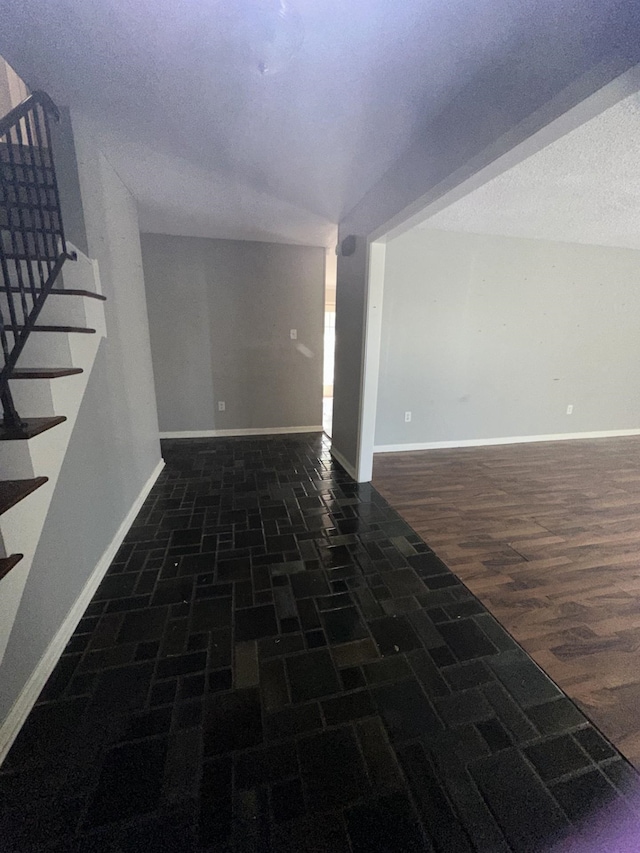 unfurnished room with a textured ceiling