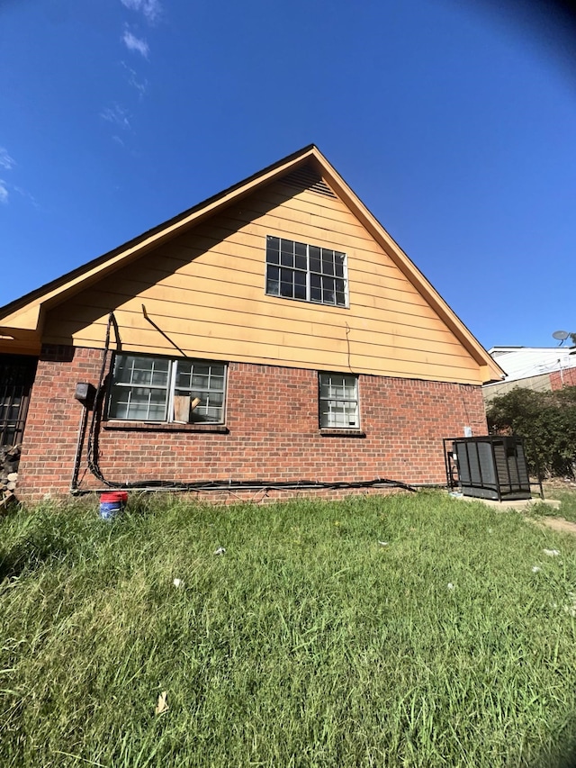 view of side of home featuring a lawn