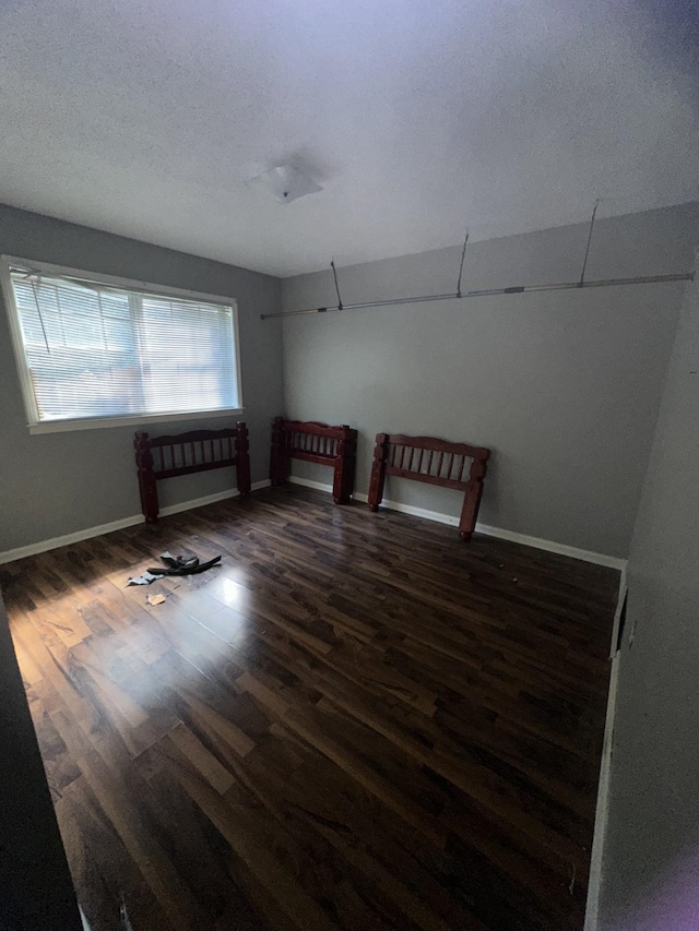 interior space with dark wood-type flooring and a textured ceiling