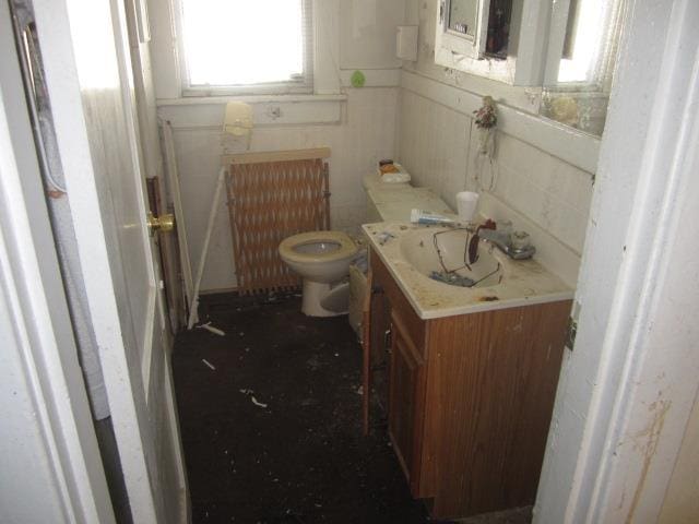 bathroom featuring vanity, radiator heating unit, and toilet