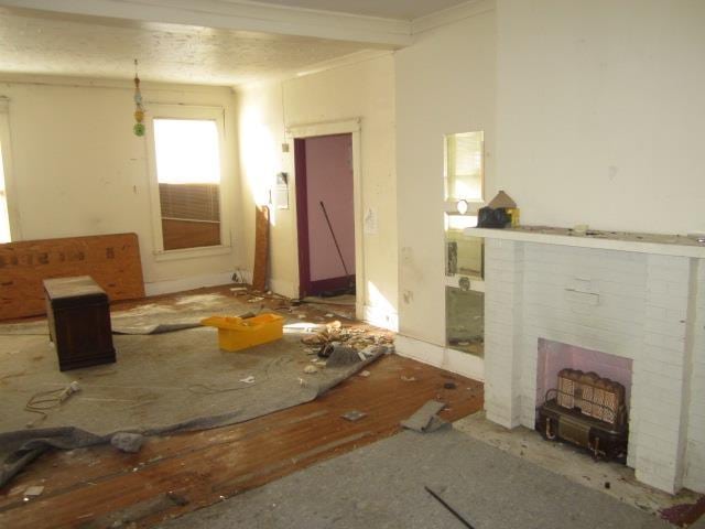 misc room with a brick fireplace and ornamental molding