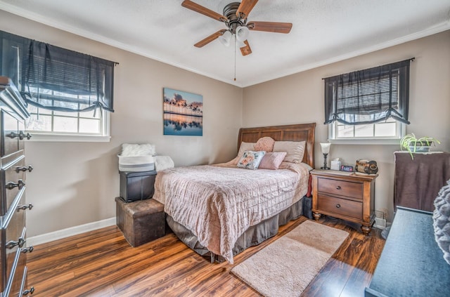 bedroom featuring ceiling fan, ornamental molding, and dark hardwood / wood-style floors