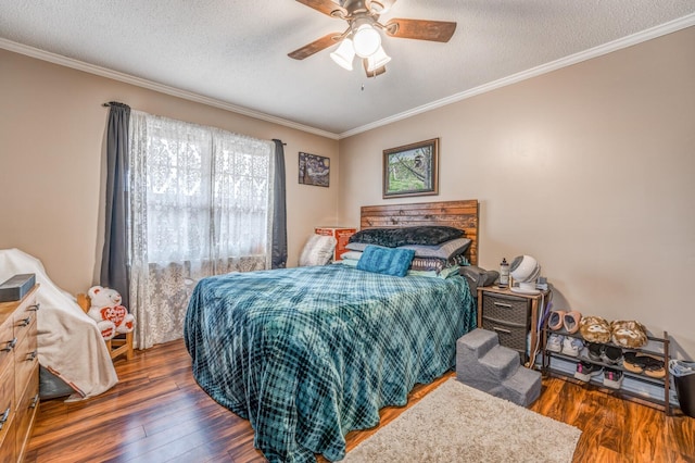 bedroom with ornamental molding, dark hardwood / wood-style floors, ceiling fan, and a textured ceiling