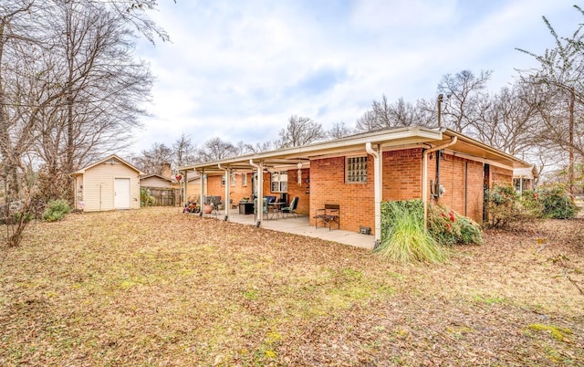 back of house featuring a shed and a patio