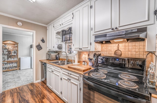 kitchen featuring white cabinetry, sink, decorative backsplash, black range with electric stovetop, and light wood-type flooring