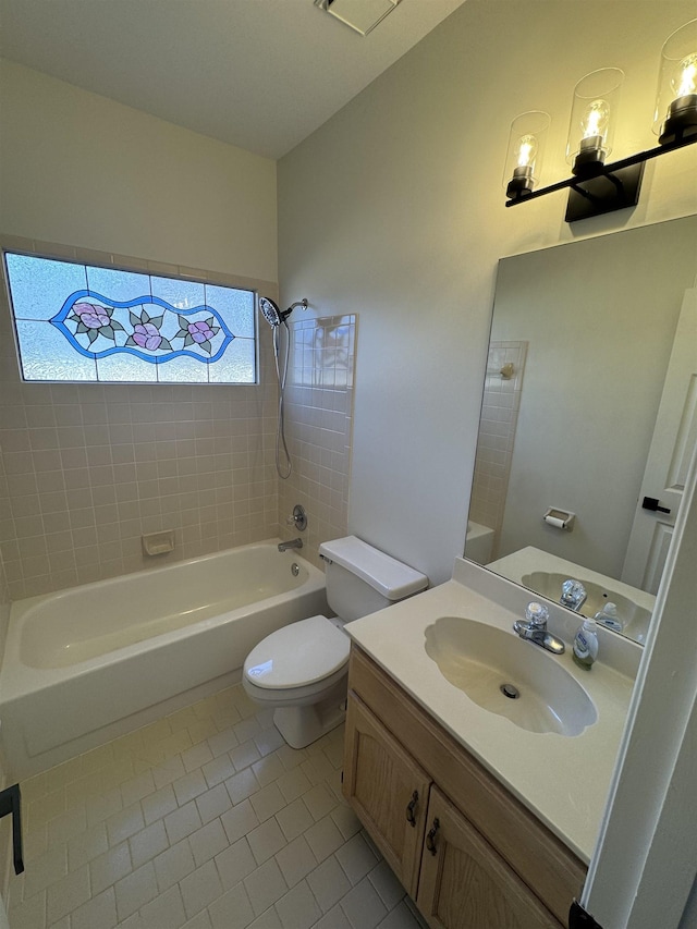 full bathroom featuring vanity, tiled shower / bath, tile patterned floors, and toilet