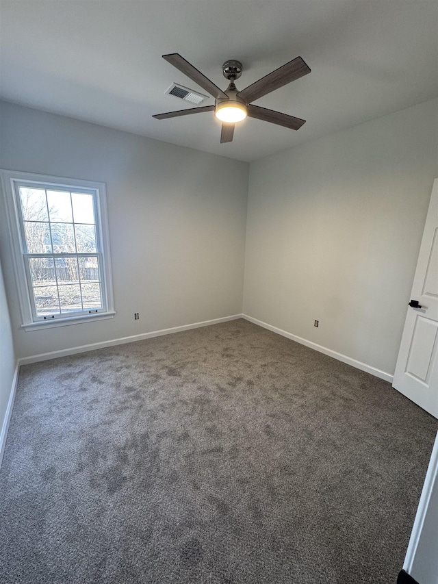 unfurnished room with ceiling fan and dark colored carpet