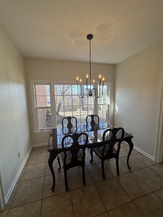 unfurnished dining area featuring dark tile patterned flooring and an inviting chandelier