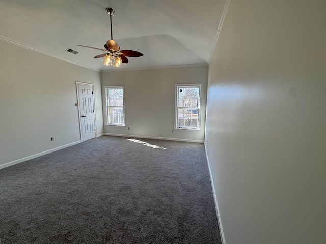 empty room featuring crown molding, ceiling fan, carpet flooring, and vaulted ceiling