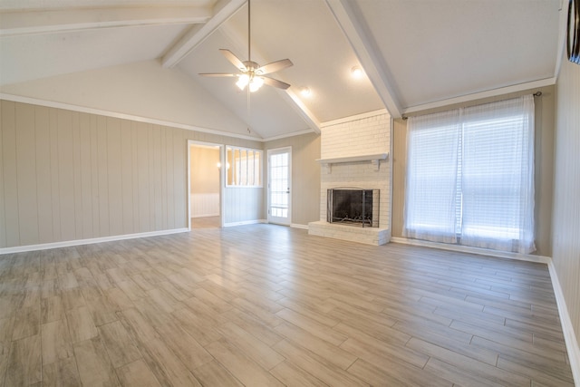 unfurnished living room with a brick fireplace, light hardwood / wood-style flooring, vaulted ceiling with beams, and ceiling fan