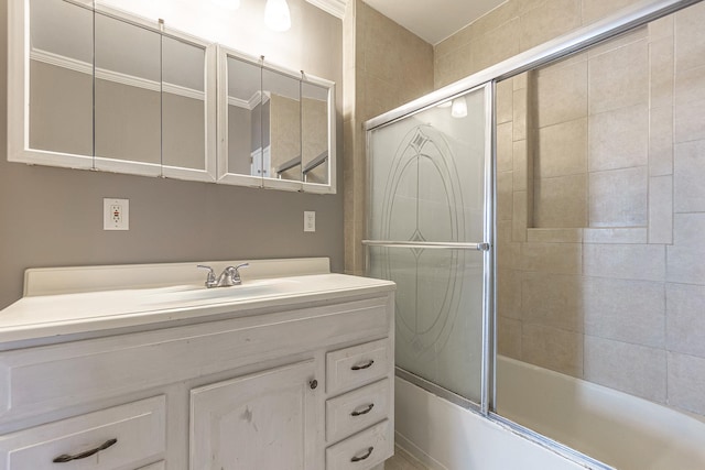 bathroom with vanity and shower / bath combination with glass door