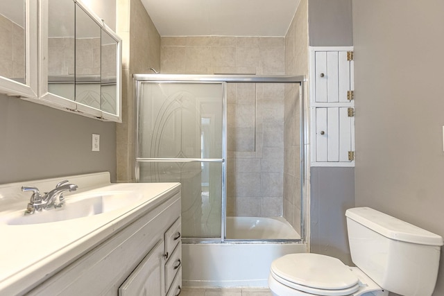 full bathroom with enclosed tub / shower combo, vanity, toilet, and tile patterned flooring