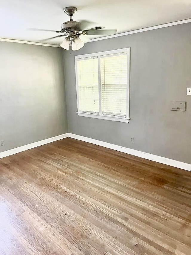 empty room with hardwood / wood-style floors and ceiling fan