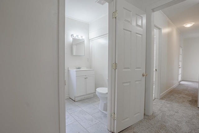 bathroom with crown molding, vanity, tile patterned floors, and toilet