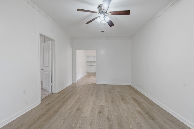 spare room featuring crown molding, ceiling fan, and light wood-type flooring