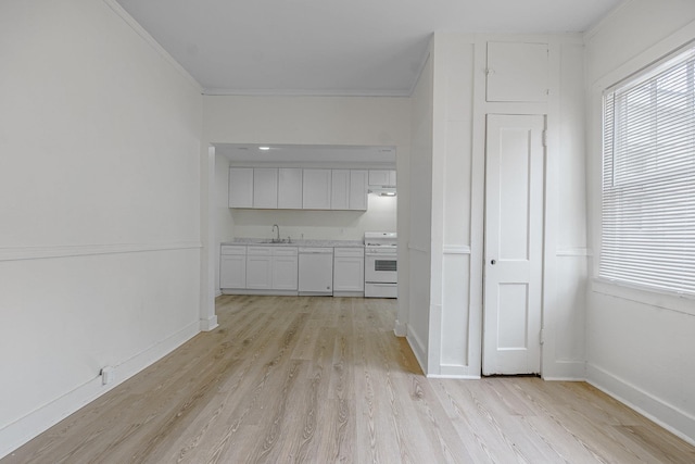 interior space with white cabinetry, white appliances, plenty of natural light, and light wood-type flooring