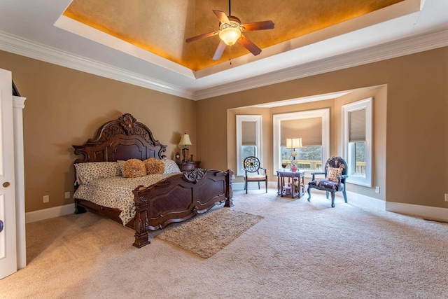 bedroom with ceiling fan, ornamental molding, a raised ceiling, and light carpet