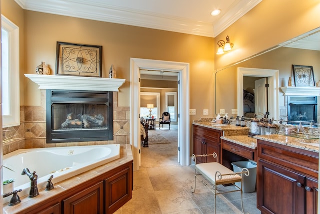 bathroom with vanity, ornamental molding, and a tub