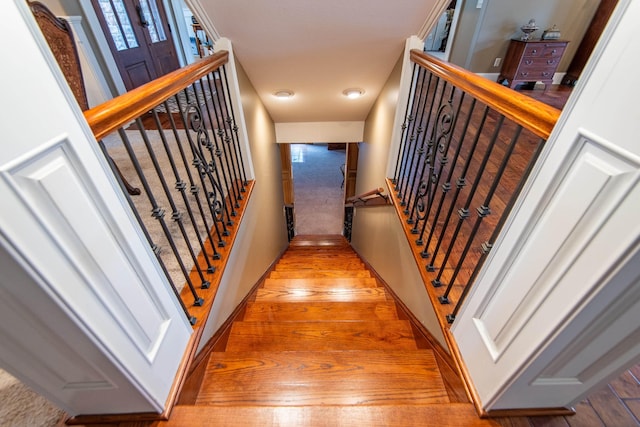 stairway with hardwood / wood-style flooring