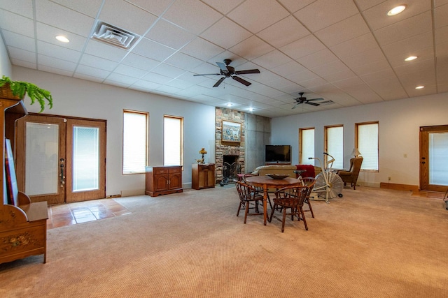 carpeted dining room featuring a fireplace, french doors, ceiling fan, and a paneled ceiling