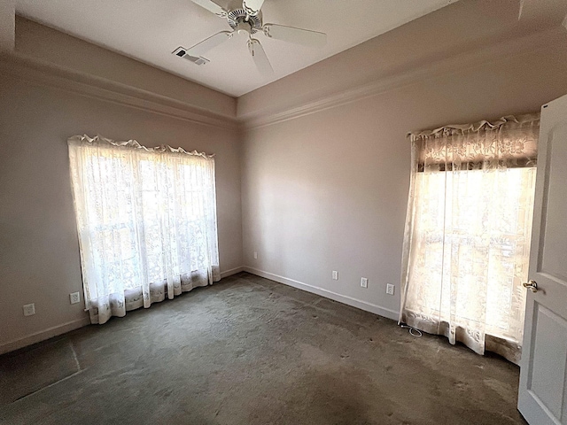 unfurnished room with ceiling fan and dark colored carpet