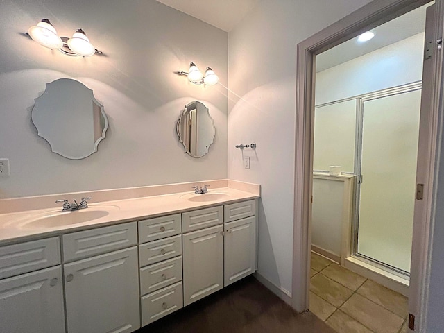 bathroom featuring tile patterned flooring, vanity, and walk in shower