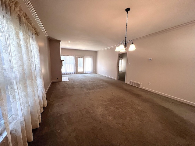 unfurnished room featuring ornamental molding, dark carpet, and a notable chandelier