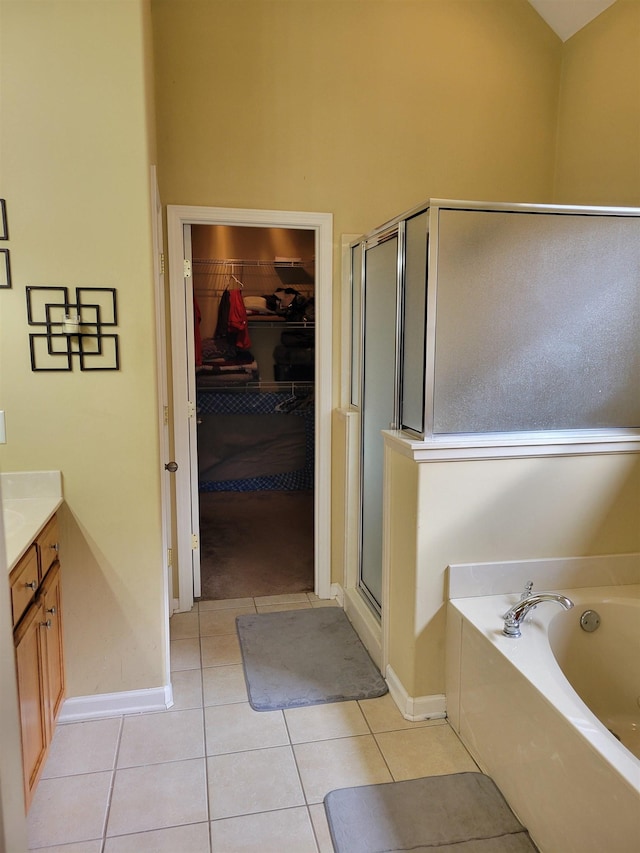 bathroom with tile patterned flooring, vanity, and independent shower and bath