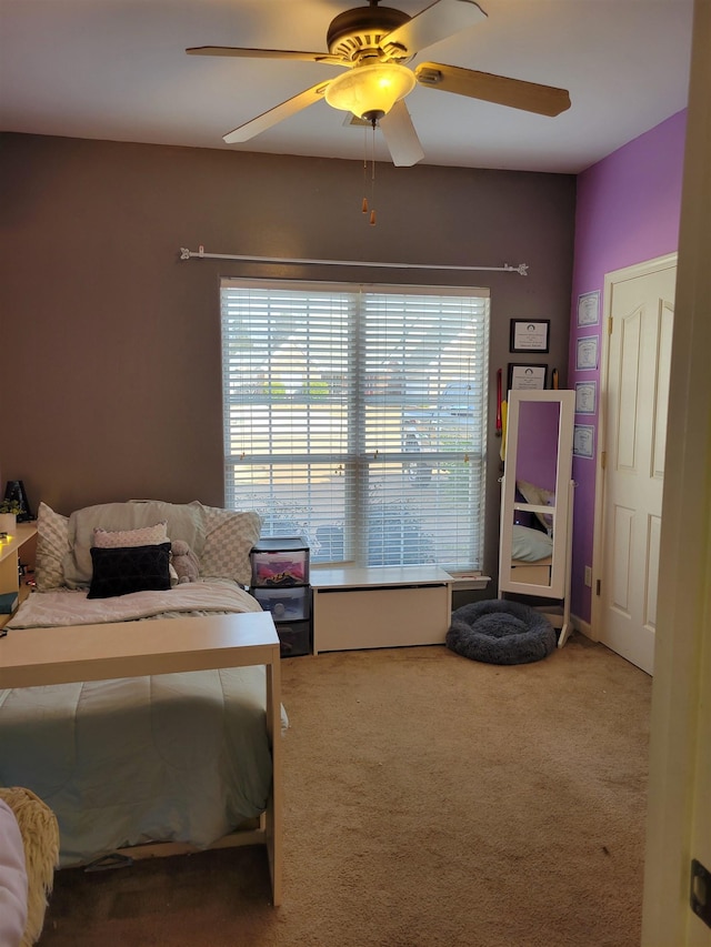 carpeted bedroom with multiple windows and ceiling fan