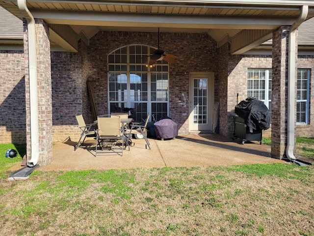 exterior space featuring area for grilling and ceiling fan