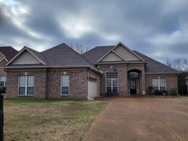 view of front of house with a garage and a front lawn