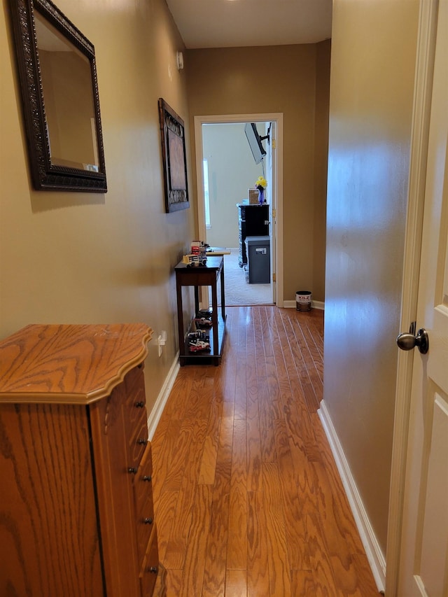 corridor with hardwood / wood-style floors