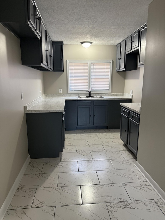 kitchen with sink and a textured ceiling