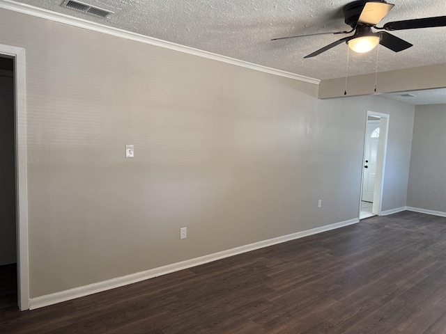 empty room with ceiling fan, dark wood-type flooring, and a textured ceiling