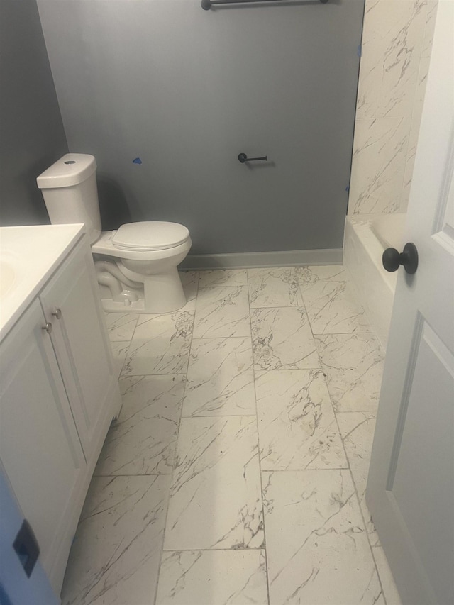 153 Caldwell Ave, Memphis, TN 38107 - full bathroom with vanity, marble look tiles, toilet, a bathtub, and baseboards