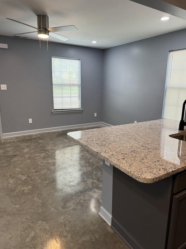 153 Caldwell Ave, Memphis, TN 38107 - kitchen featuring finished concrete floors, baseboards, a ceiling fan, light stone counters, and recessed lighting