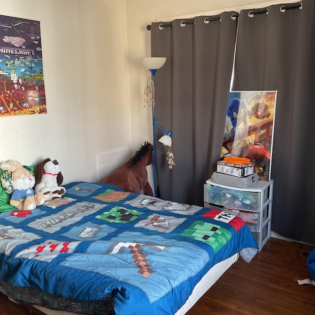 bedroom with dark hardwood / wood-style flooring