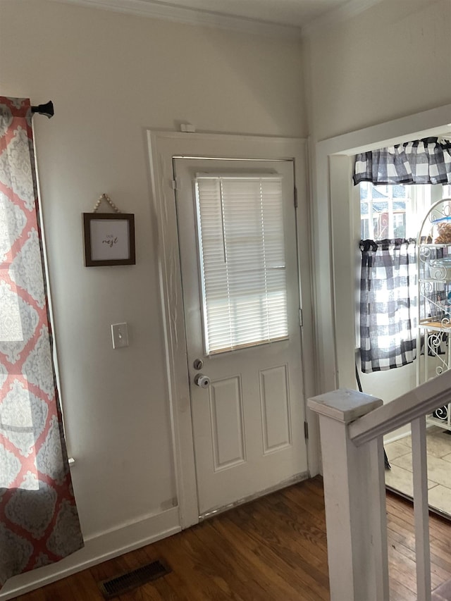 entryway with wood-type flooring and crown molding