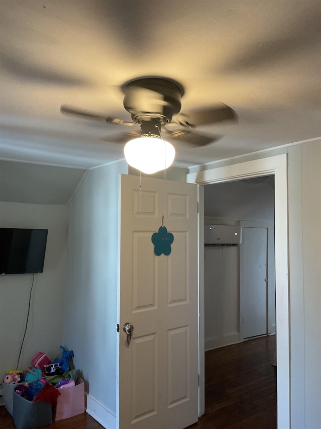 hallway featuring lofted ceiling, dark hardwood / wood-style floors, and a wall mounted AC