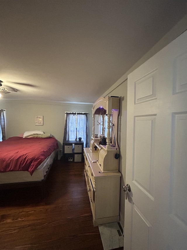 bedroom featuring crown molding and dark hardwood / wood-style floors