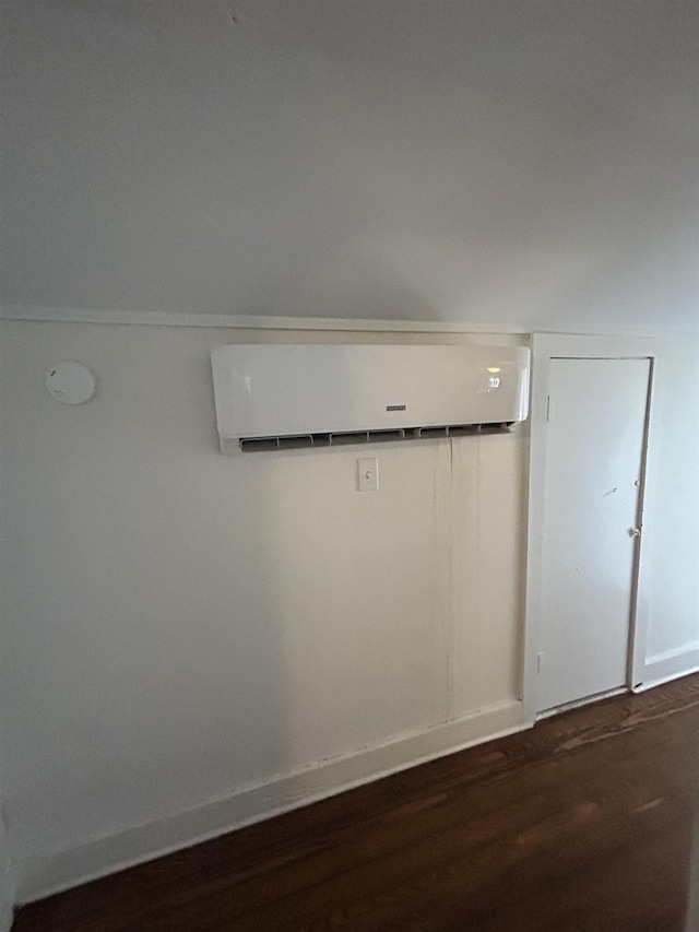 details featuring wood-type flooring and an AC wall unit