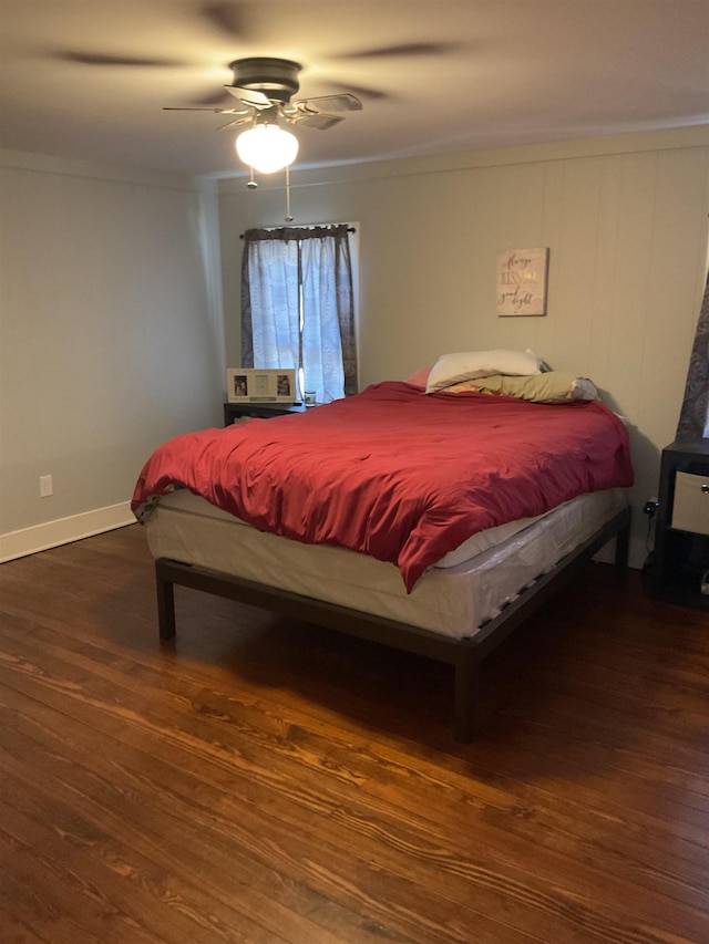 bedroom with ornamental molding, dark wood-type flooring, and ceiling fan