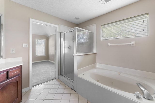 bathroom featuring vanity, tile patterned flooring, a textured ceiling, and separate shower and tub