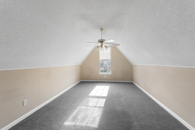 additional living space featuring carpet floors, a textured ceiling, vaulted ceiling, and ceiling fan