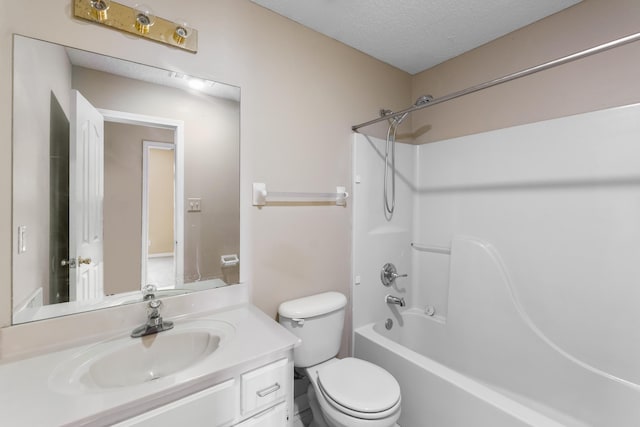 full bathroom with  shower combination, toilet, a textured ceiling, and vanity