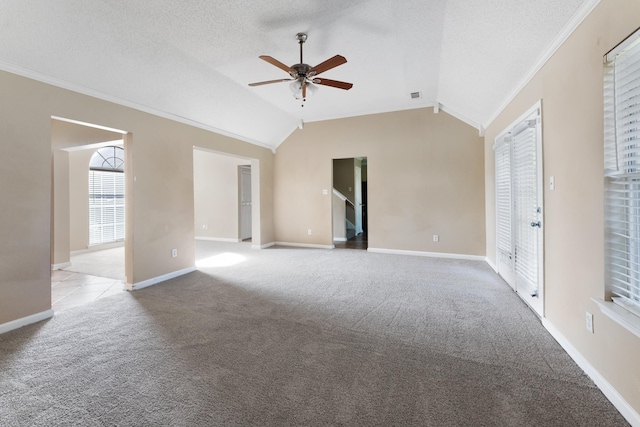 carpeted spare room featuring ceiling fan, lofted ceiling, ornamental molding, and a textured ceiling